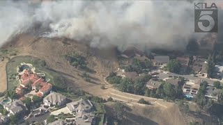 Brush fire threatens home in Los Angeles County
