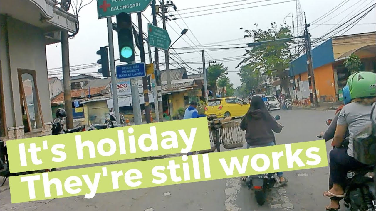 Riding on holiday traffic road in busy surabaya city Indonesia - So many people works hard today!