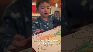 Toddler coloring while waiting at a restaurant