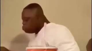 Black man falls off chair