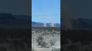 Car Passenger Films Two Mini Tornados Forming While on Highway