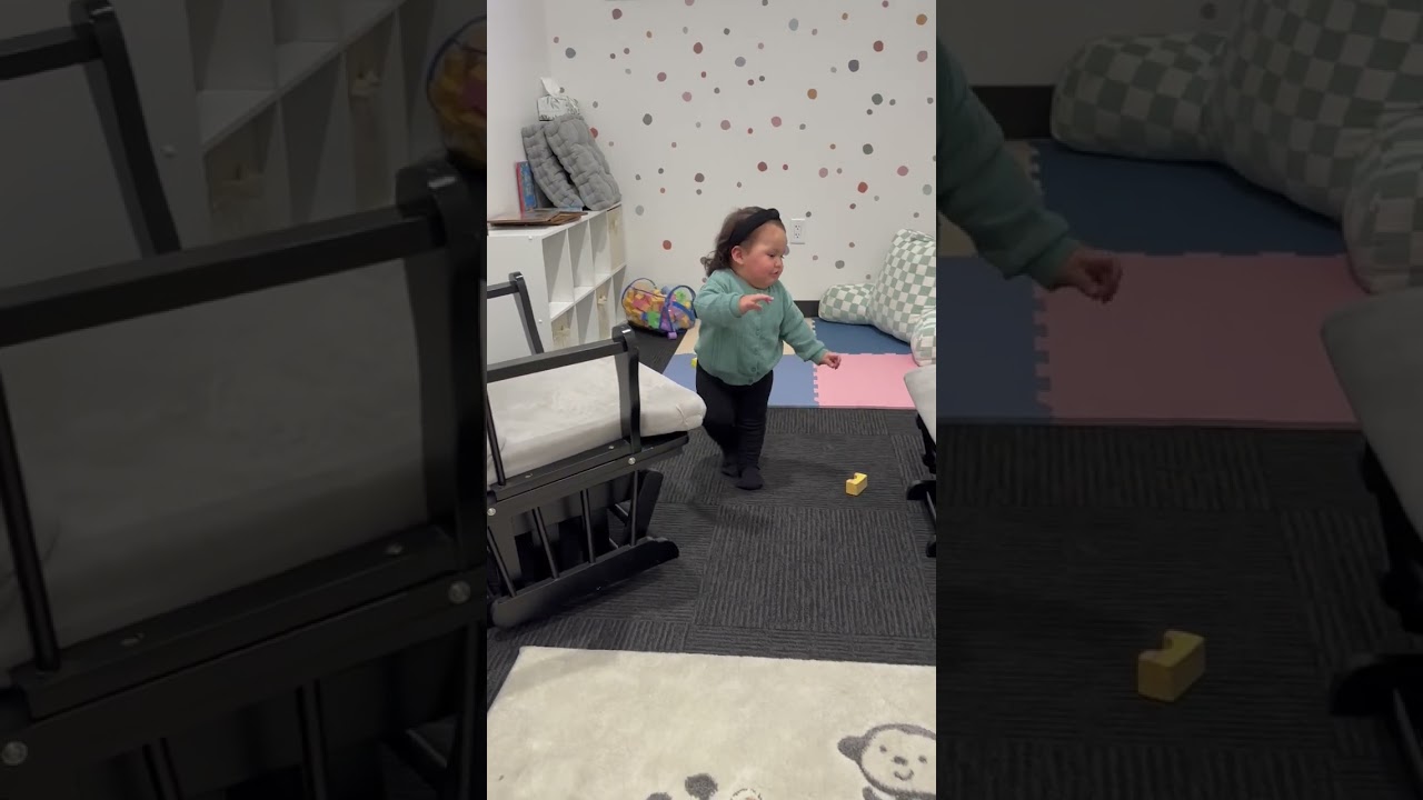 Little girl walks in bedroom then loses balance and taps rocking chair then bumps head on foot stool