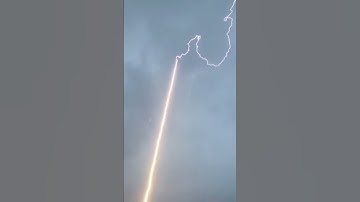 Lightning bolt is guided to the ground through rocket trail