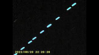 STRING OF SOMETHING FLYING ACROSS THE SKY
