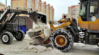 :    .     . Clearing snow with front loaders