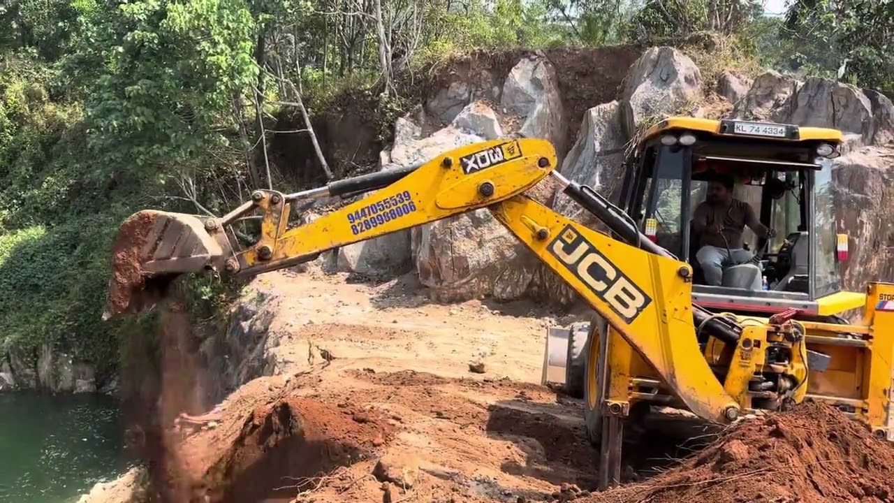 Jcb 3dx digging and moving soil for land filling 