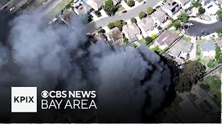 Watch: Flames torch nearby homes and cars in Alameda County