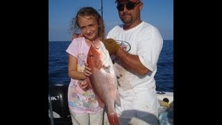 Small girl catching big red snapper Offshore deep sea fishing Destin Florida
