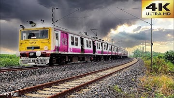 High speed Electric Multiple Unit local train fast and furious skipping sharp curve with drizzling