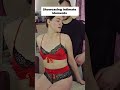 He Touches Her Chest While She Sits On The Bed