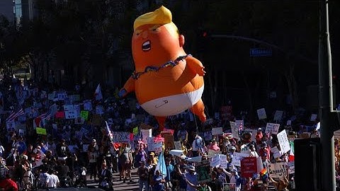 Tens of thousands of people take to the streets in nationwide anti-Trump 