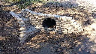 Building a cement bag retaining wall around a culvert by pouring dry concrete mix in small lunch bags and stacking them like bricks. 