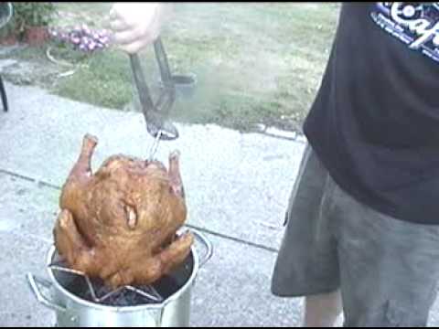 Pulling Up Turkey Out Of the Fryer with 15 minutes left to cook