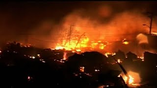 A huge fire destroyed at least 50 flooded homes in the Breezy Point section of New York City's Queen
