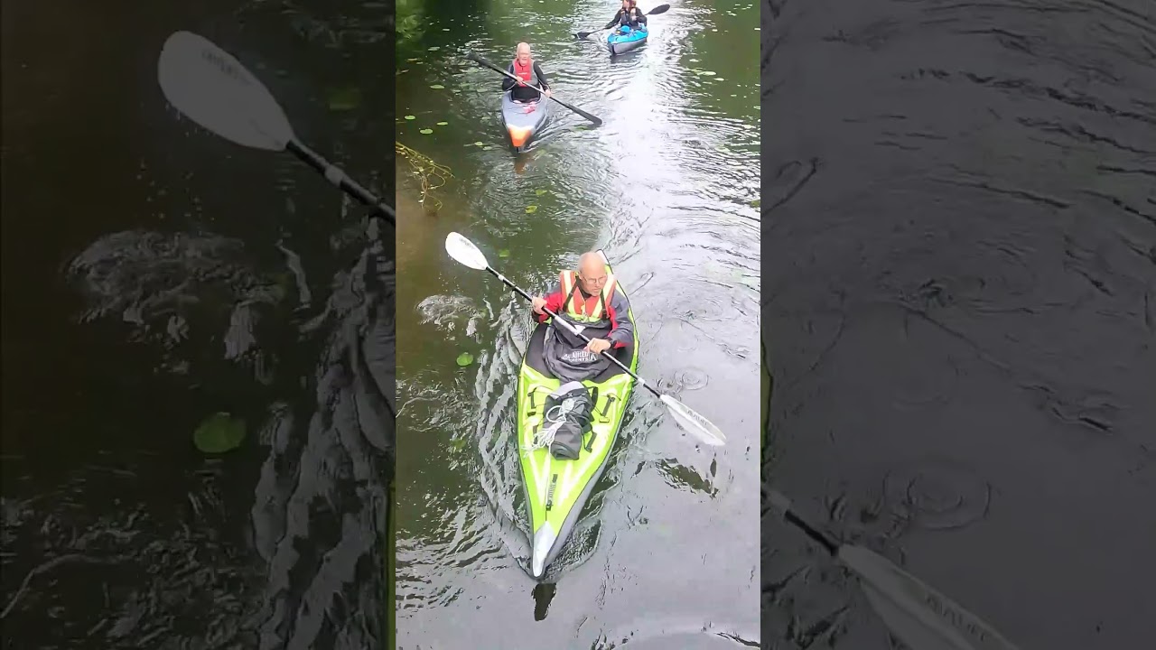 Pakboat and inflatable kayaks passing under bridge - paddle event after Swedish Air Kayak Day