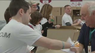 Dozens Of Volunteers Packing Meal Boxes For Families In Need