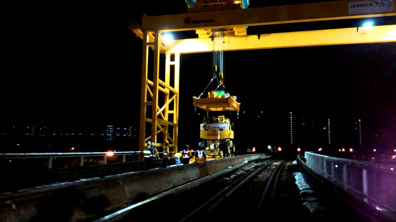 Road rail vehicle being hoisted on to train tracks YouTube
