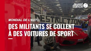 Au Mondial de l’auto, des militants se collent à des voitures de sport