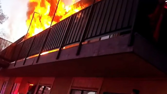 Cop Climbs On Dumpster To Rescue Woman Trapped On Balcony