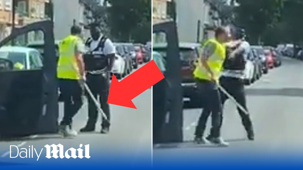 Shocking moment angry driver attacks traffic warden with wooden pole