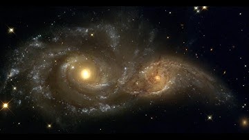 Two Spiral Galaxies Colliding With Each Other