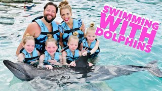 Quadruplets Swimming With DOLPHINS