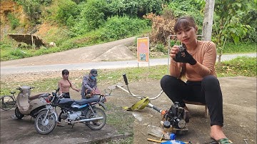 The mechanic girl fixed the lawn mower, cleaning the entire inside of the engine.
