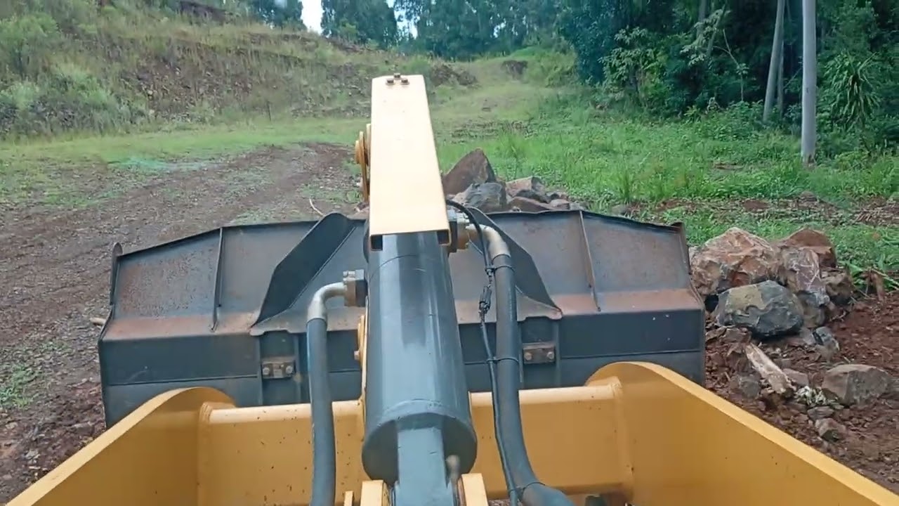 Carregando pedras & britado cascalhos na chuva