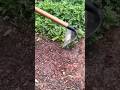 digging the garden soil thoroughly using a manual hoe with a long wooden handle