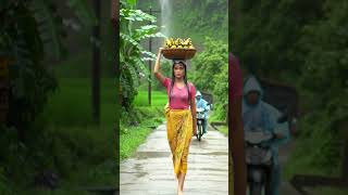 A Young Woman Is Walking Confidently Down A Narrow Rural Road In The Rain.
