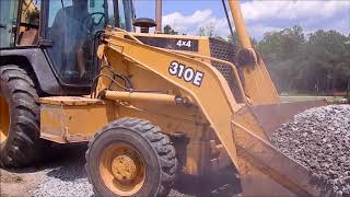 Backhoe Spreading Gravel