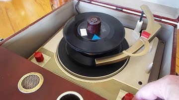 Symphonic record player playing a stack of 45