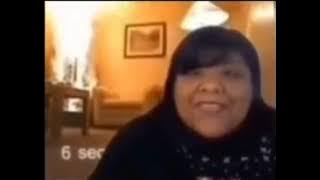 Girl speaking Spanish and saying merry Christmas while Christmas tree burns in background