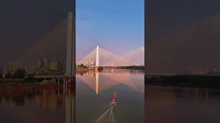 Yellow Crane Tower by the Yangtze. Girls on hydrofoils glide gracefully over the rolling river