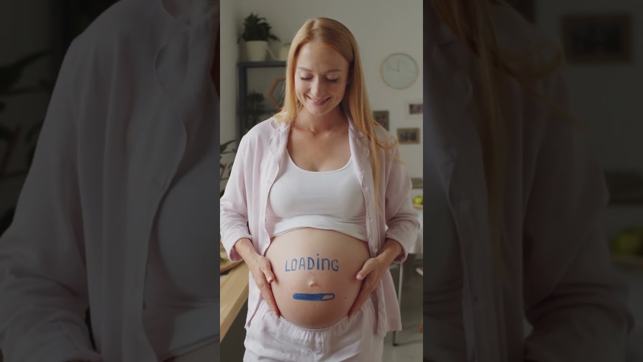 Pregnant Happy Woman with Loading Sign Painted on Pregnant Belly