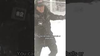 Meteorologist John Elliott makes snow angels during blizzard