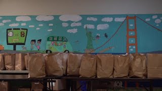 Volunteers in Hazleton prep food bags for giveaway
