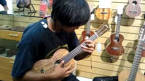 Jared testing the Collings ukulele at Island Guita...