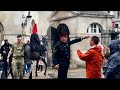 Angry boss  soldier screamed but guard uses his horse and loud voice to move the tourists away