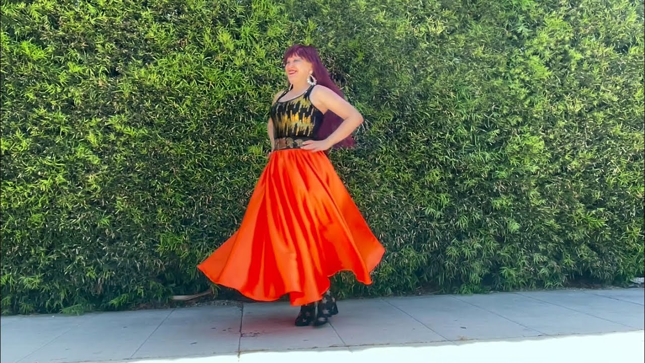 Orange satin maxi skirt, sequin top, big earrings. Ameynra designs by Sofia Goldberg 