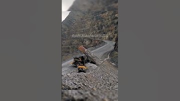 Haul Truck Dumping at the Edge of Mine Road: Material Disposal in Action