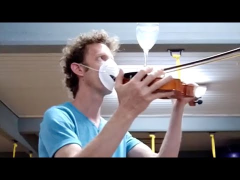 Man Wearing Facemask Plays Happy Birthday Tune on his Violin While Balancing Glass on bow