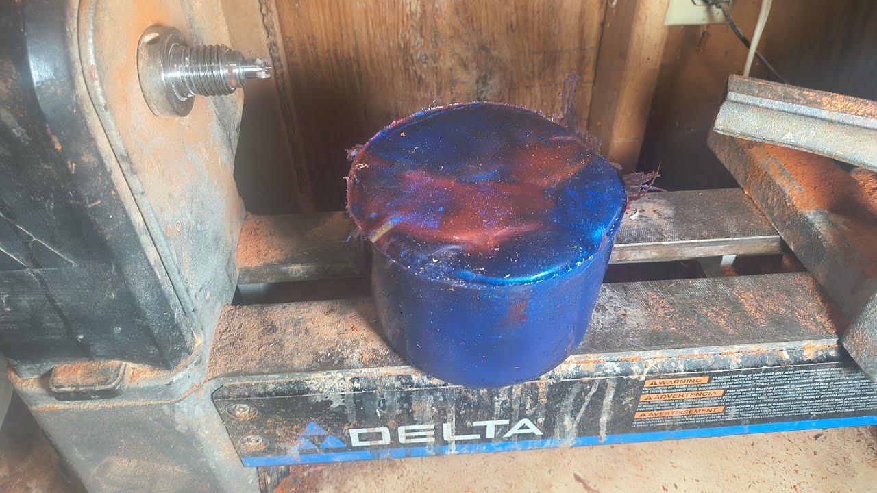 Turning a resin, wood turned jar, red and blue resin with padauk wood.