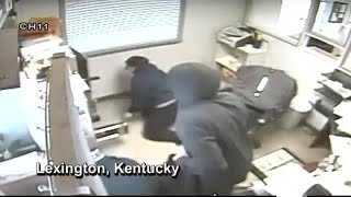 Masked robbers caught on camera holding employees at gunpoint, forcing them to open safe