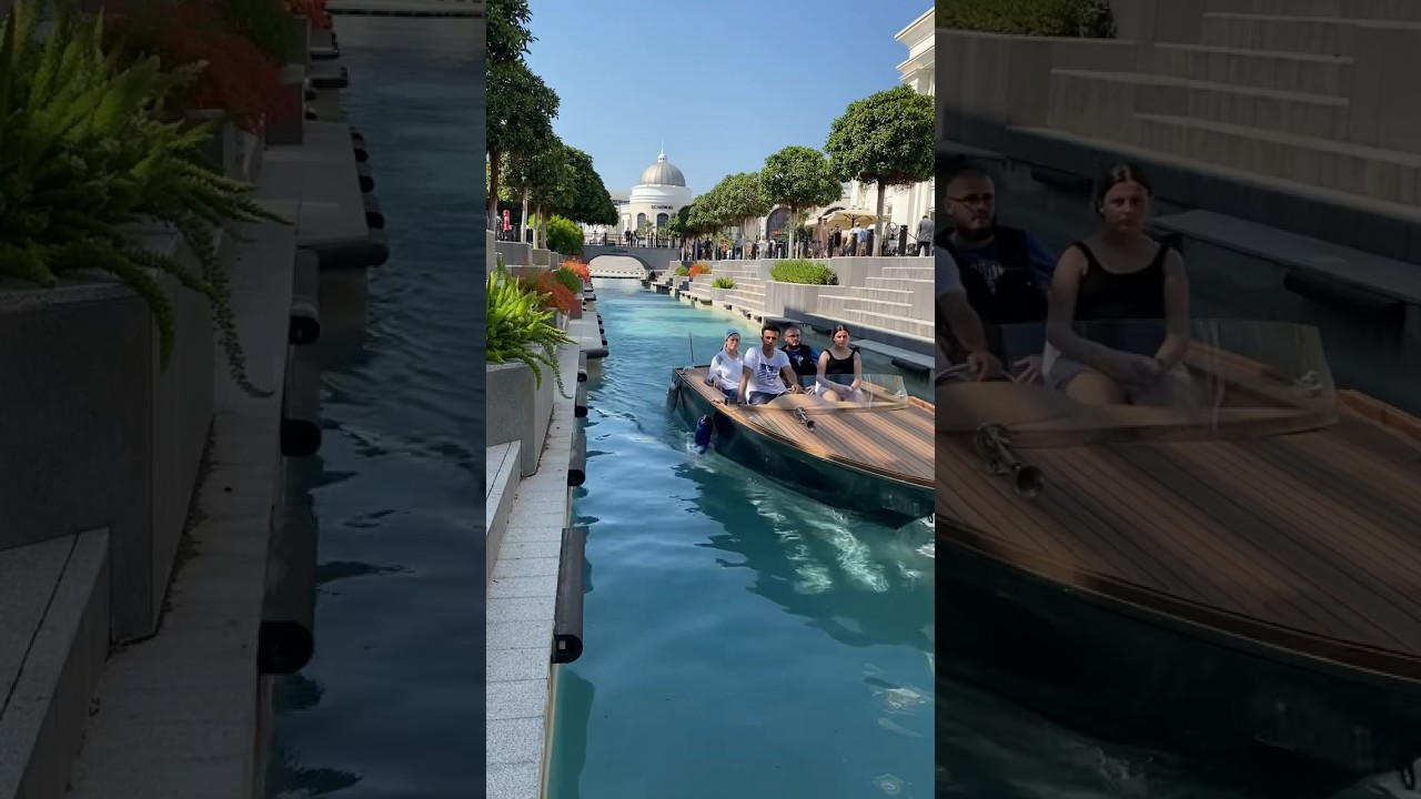 A water taxi rides tourists along an artificial canal 