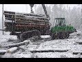 John Deere 1110E logging in snowy forest, big load, skilled operator