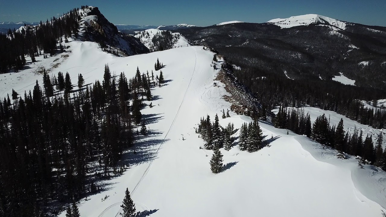 Drone video flying up the snowy Rocky Mountain ridgeline - YouTube