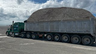 trucks are unloading 3,500 tons of gravel onto a barge S5•E12