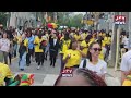 Ghanaians in Toronto march excitedly to the stadium ahead of the game.