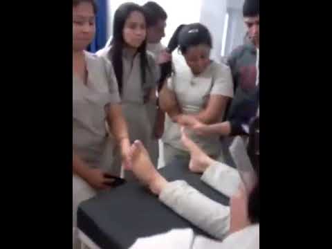 F/F feet tickling. Woman in a medical class decides to tickle a students foot during  demonstration